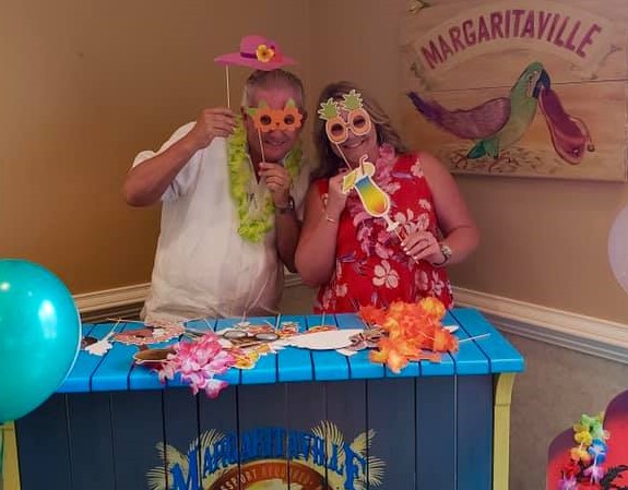 two people smiling in margaritaville-inspired costumes